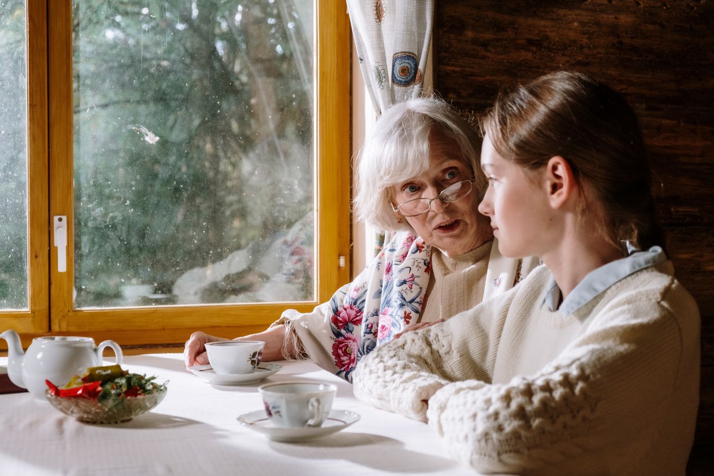 A caregiver spending time with an older adult at home